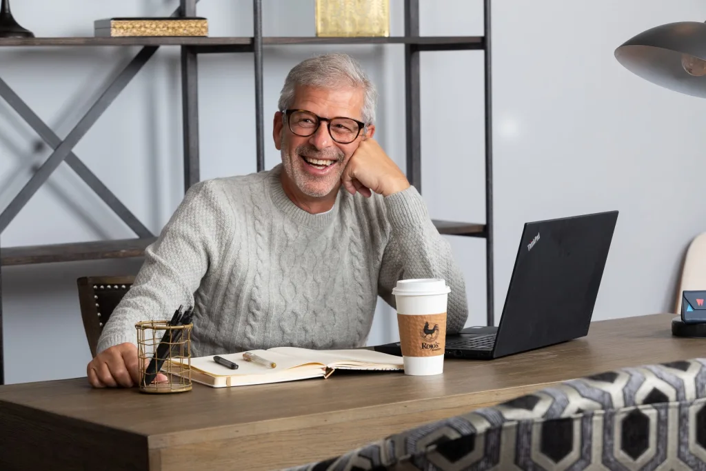 man doing work at a desk in one of the residential units